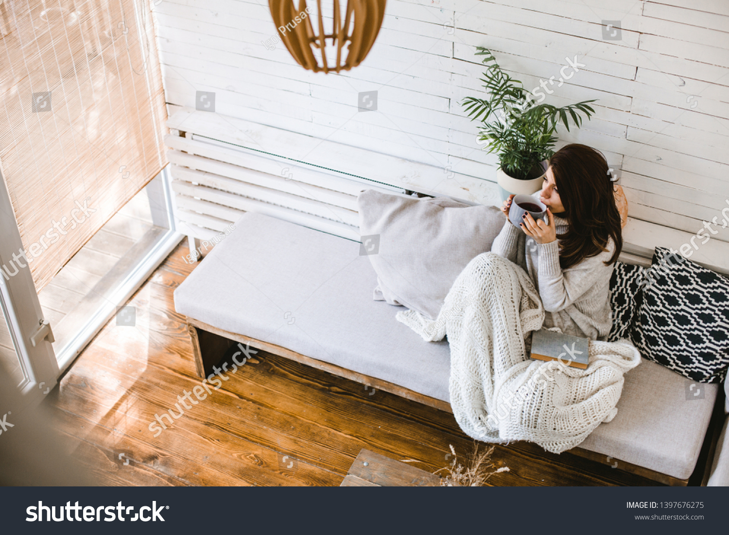 Beautiful woman enjoying cup of tea in her cosy house #1397676275