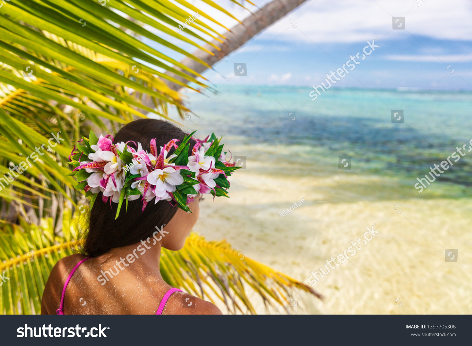 Hawaii beach woman luau dancer relaxing wearing wreath of fresh flowers on Tahiti Bora Bora, French Polynesia. #1397705306