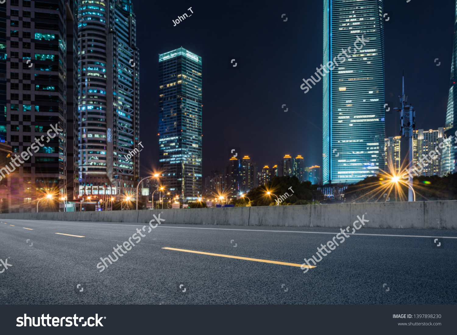 empty pavement and modern buildings in city in night #1397898230
