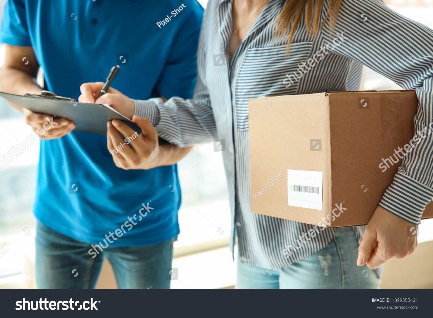 Woman signing documents to confirm receiving of order from delivery company #1398355421