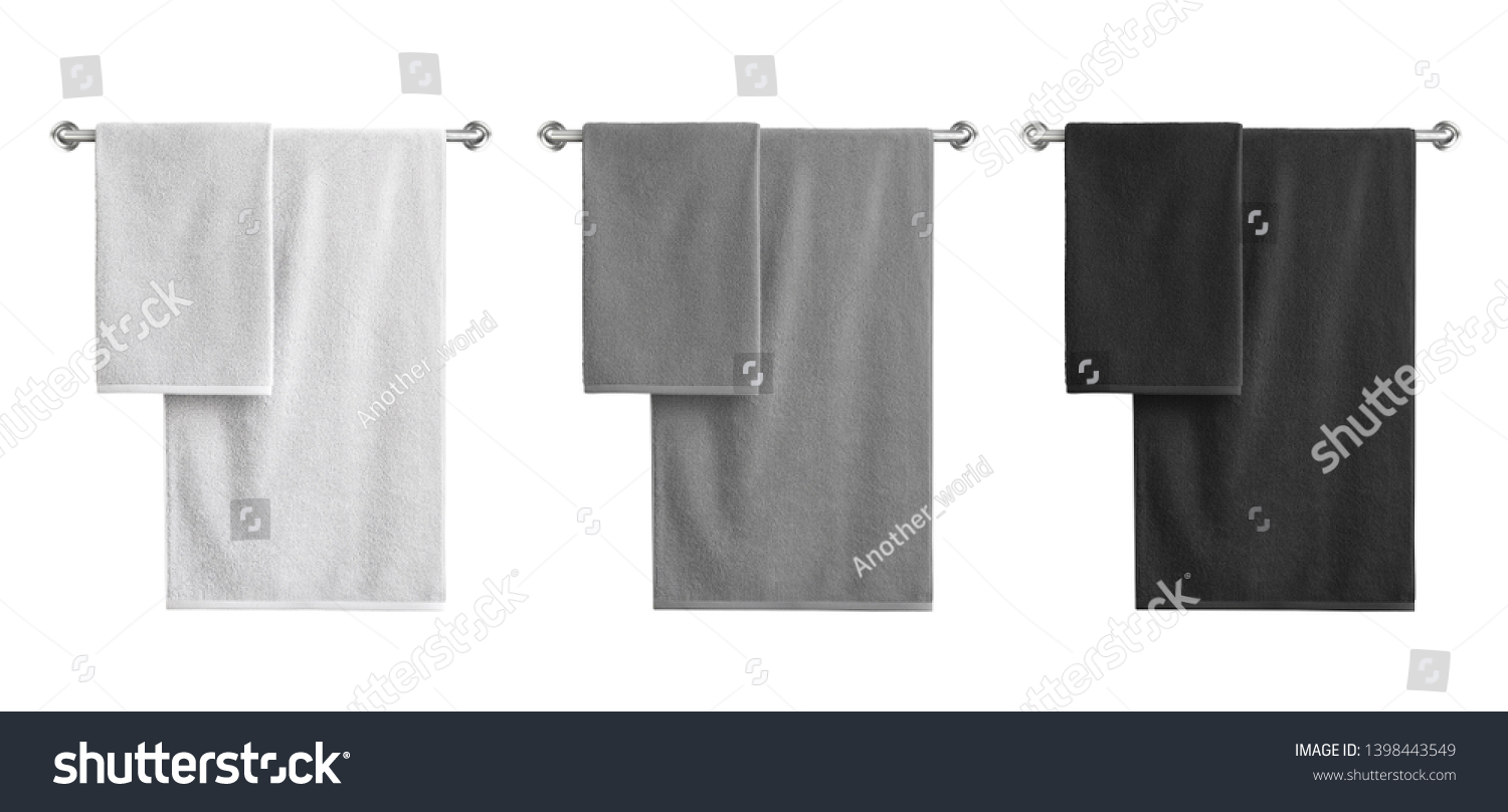 White, black and grey cotton terry towels hanging on a rail isolated  #1398443549
