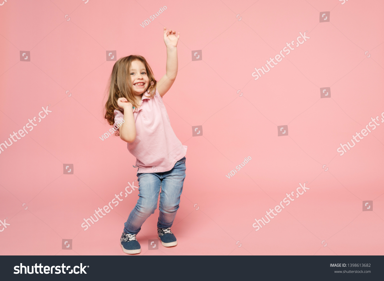 Little cute child kid baby girl 3-4 years old wearing light clothes dancing isolated on pastel pink wall background, children studio portrait. Mother's Day, love family, parenthood childhood concept #1398613682