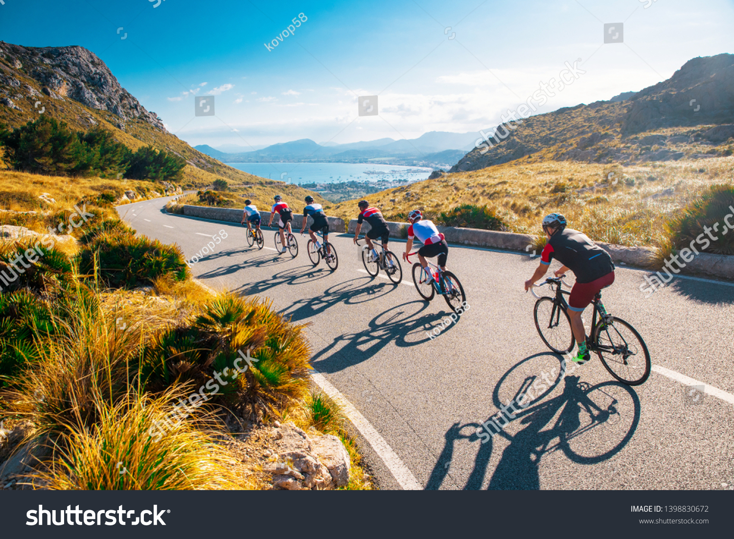 Team sport cyclist photo. Group of triathlete on bicycle ride on the road at Mallorca, Majorca, Spain. #1398830672