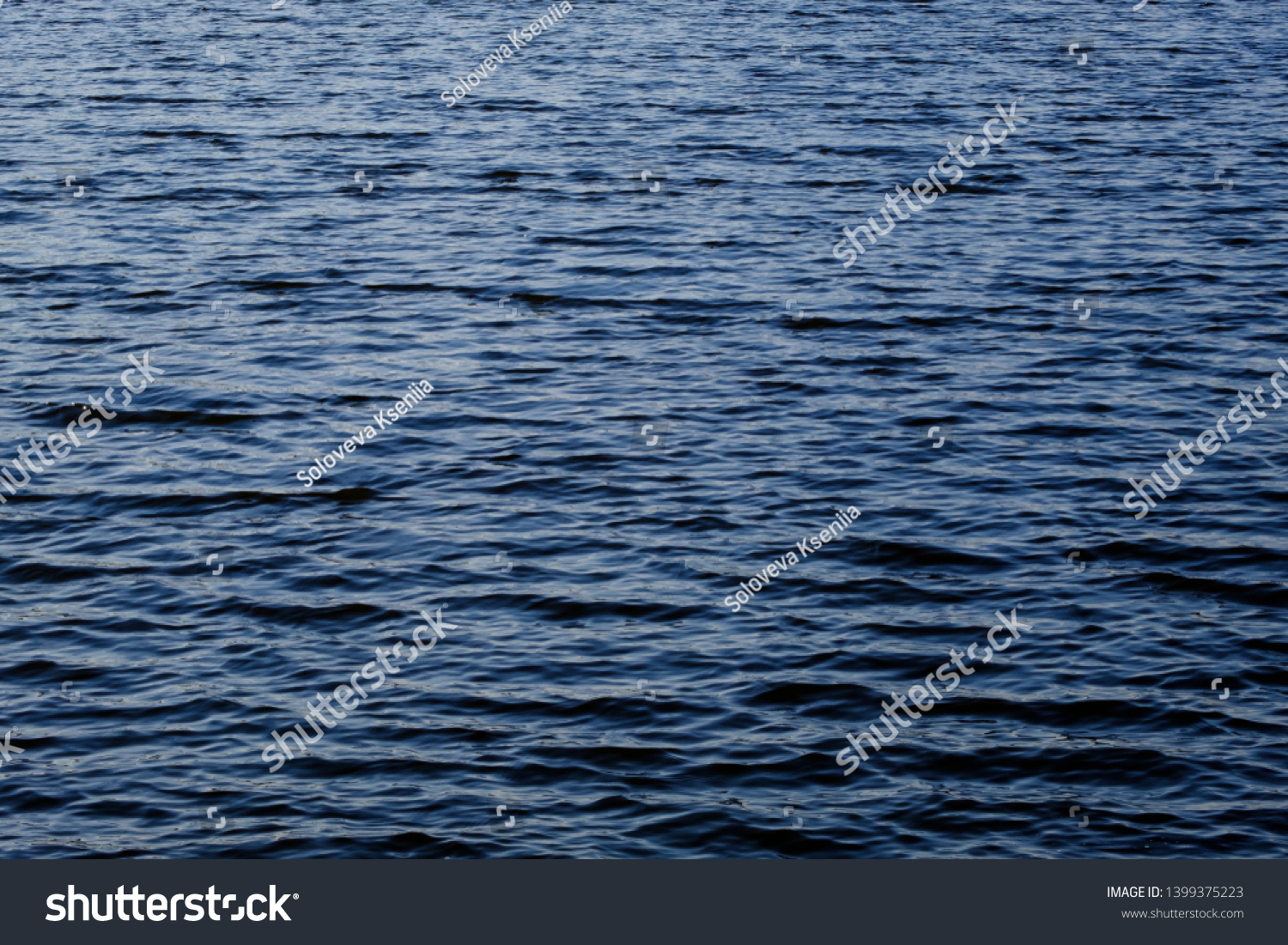 Light playing on the sea surface. Water surface. Sea surface. Water background. Blue water surface.  #1399375223