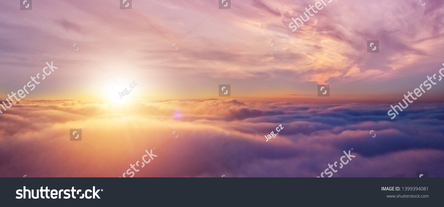 Beautiful sunset cloudy sky from aerial view. Airplane view above clouds #1399394081