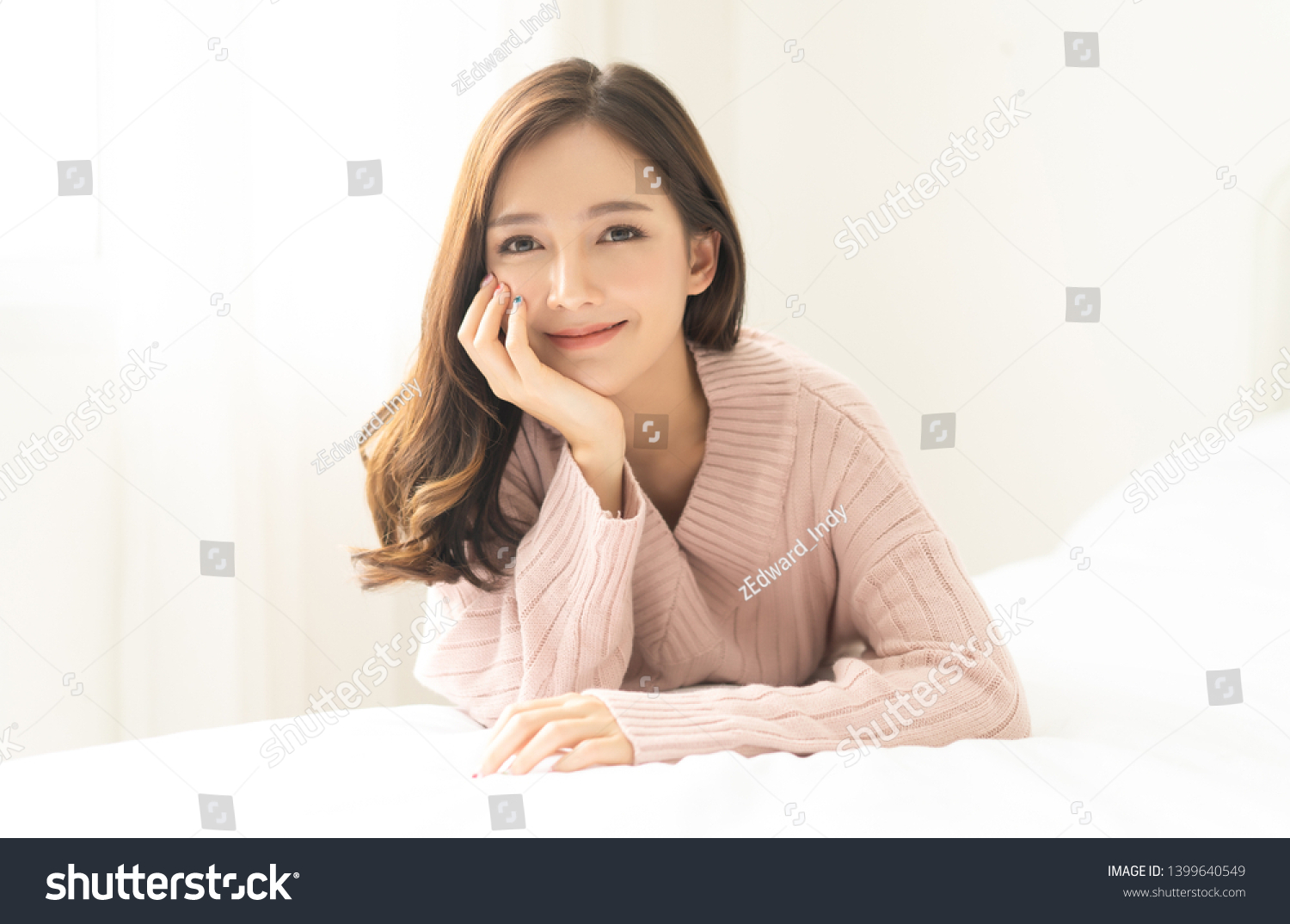 Portrait of young Asian woman smiling friendly and looking at camera in living room.Woman's face closeup. Concept woman lifestyle and winter. Autumn, winter season. #1399640549