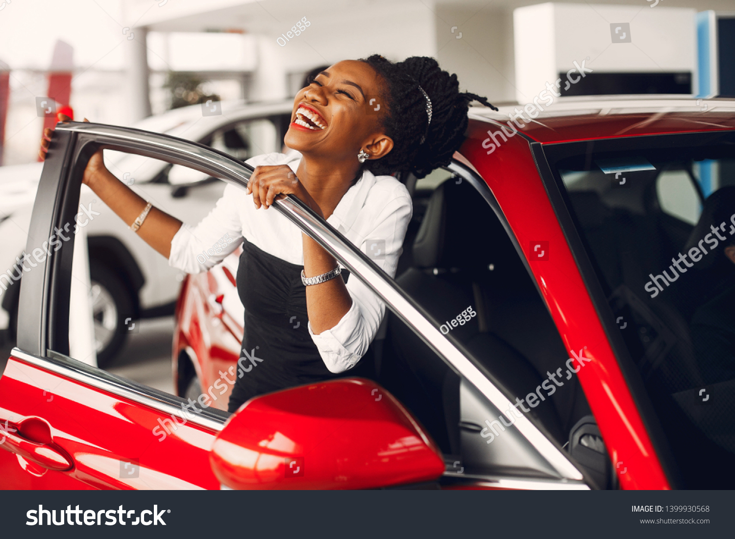 Woman buying the car. Lady in a car salon. Elegant black girl #1399930568