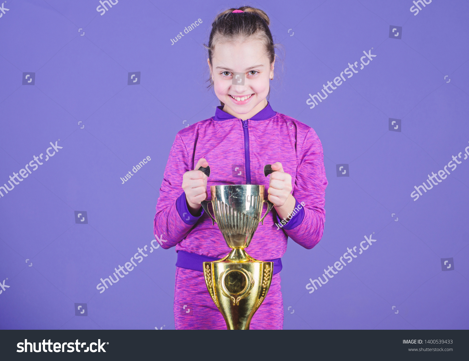 Celebrating childrens achievements great and small. Sport achievement. Celebrate victory. Girl hold golden goblet. Importance of capturing evidence of kids progress. Proud of her achievement. #1400539433