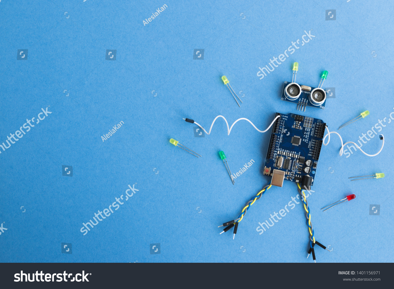 Back to school concept. A metal robot and an electronic board that can be programmed. Robotics and electronics. DIY robotics. STEM and STEAM education for kids. Free space for text. #1401156971