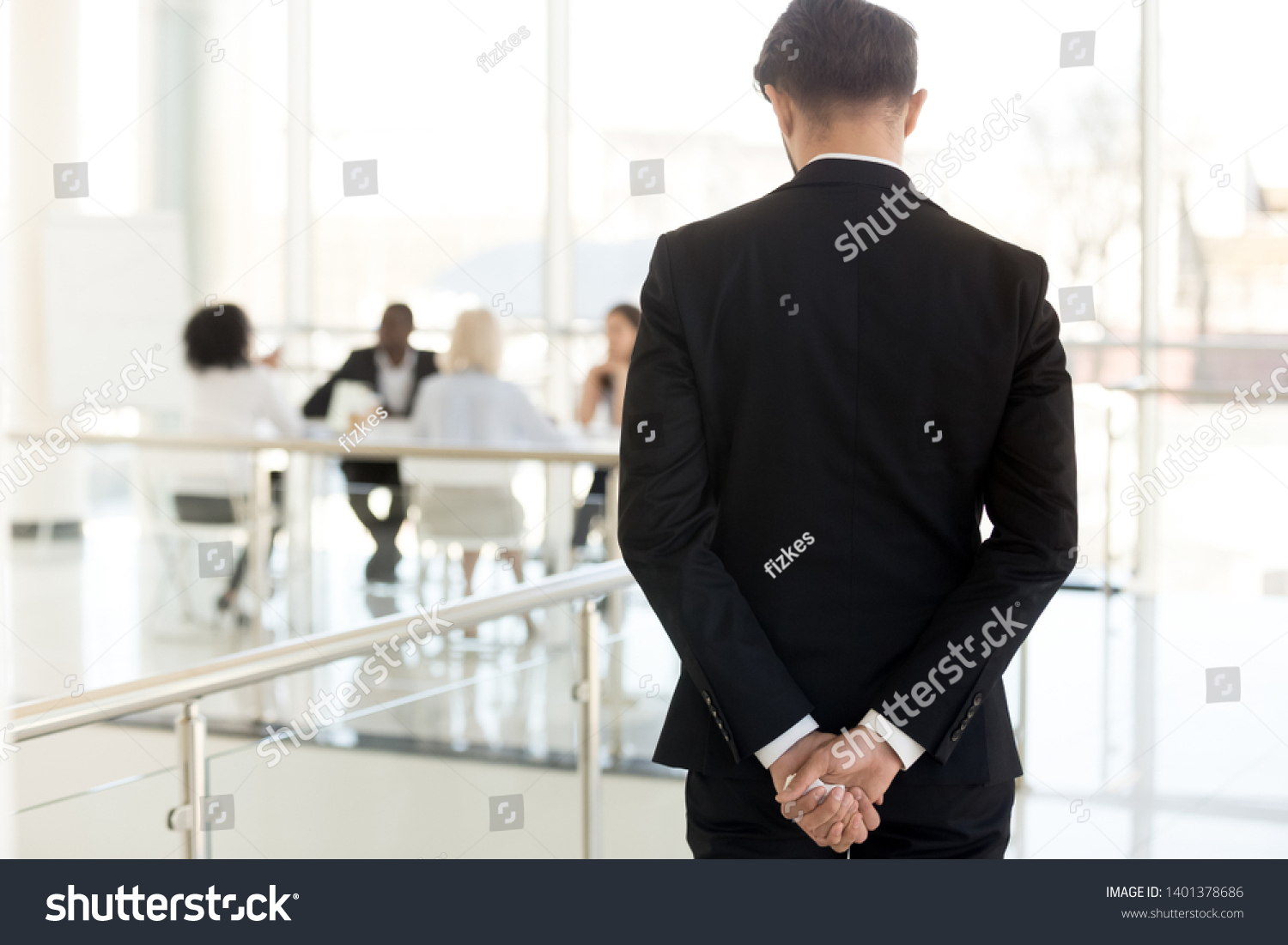 Nervous businessman waiting to enter at business meeting rear view, male employee, presenter, speaker worried about presentation for colleagues in boardroom, applicant waiting interview in hallway #1401378686
