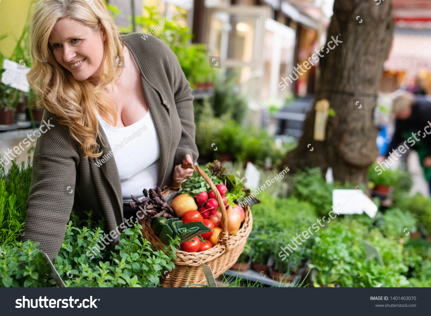 A housewife buys fresh herbs at a market #1401403070