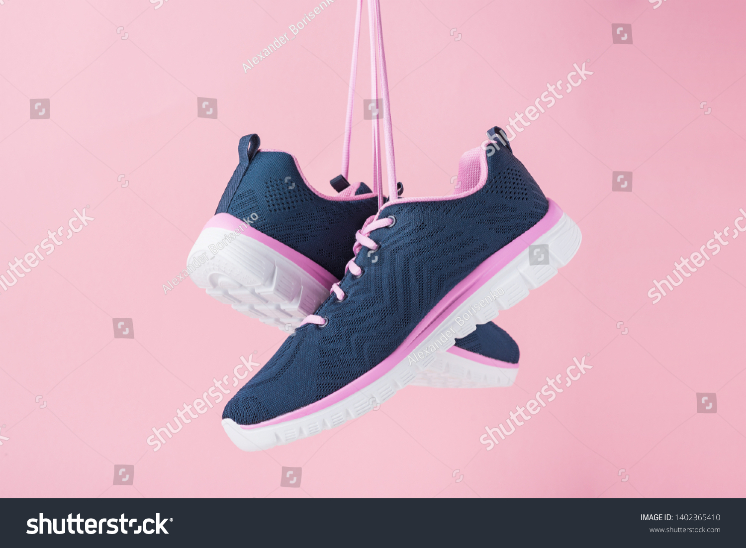 Female sneakers for run on pink background. Fashion stylish sport shoes, close up #1402365410