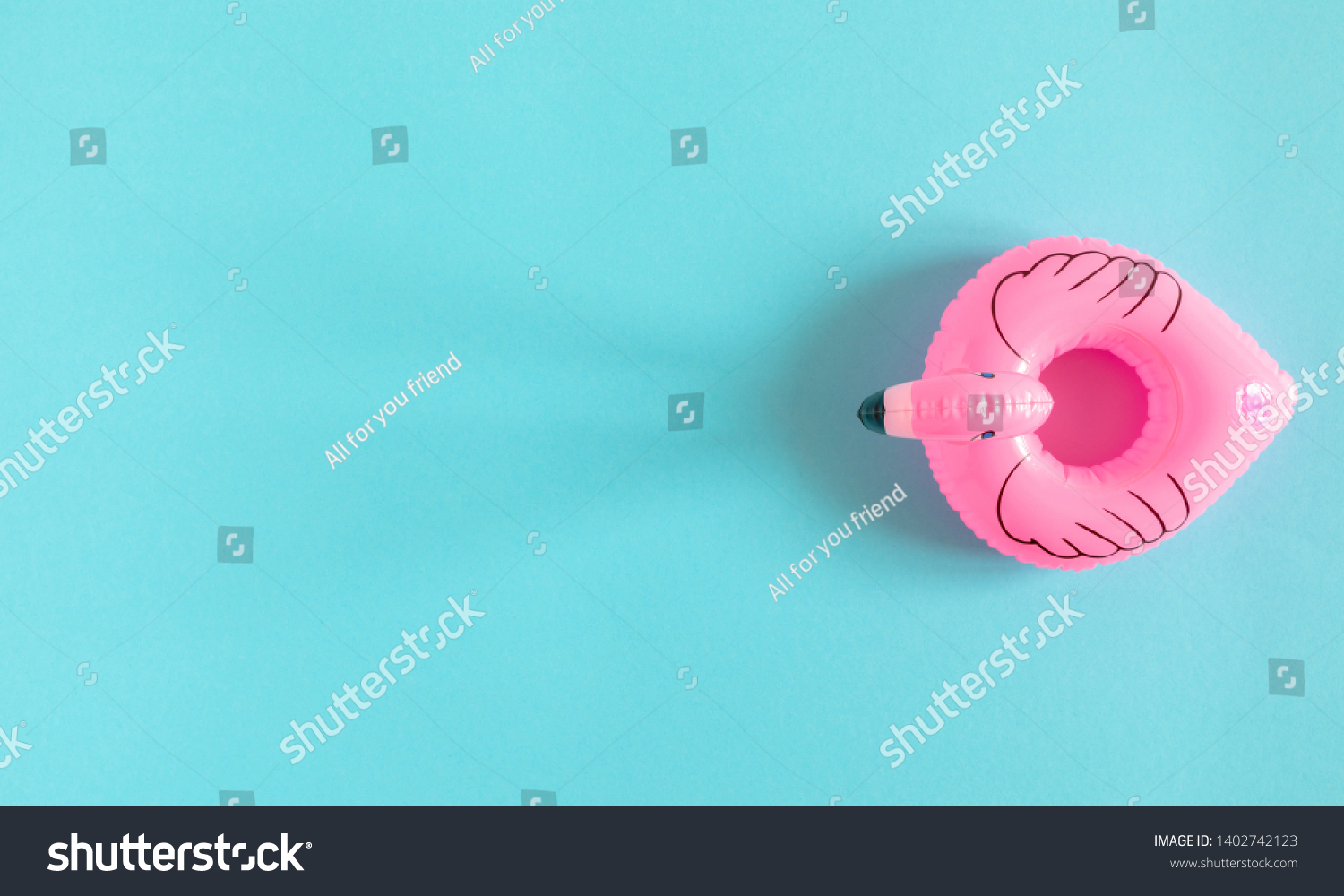 Summer beach composition. Inflatable mini flamingo on pastel blue background, pool float party, trendy summer concept. Flat lay, top view, copy space #1402742123