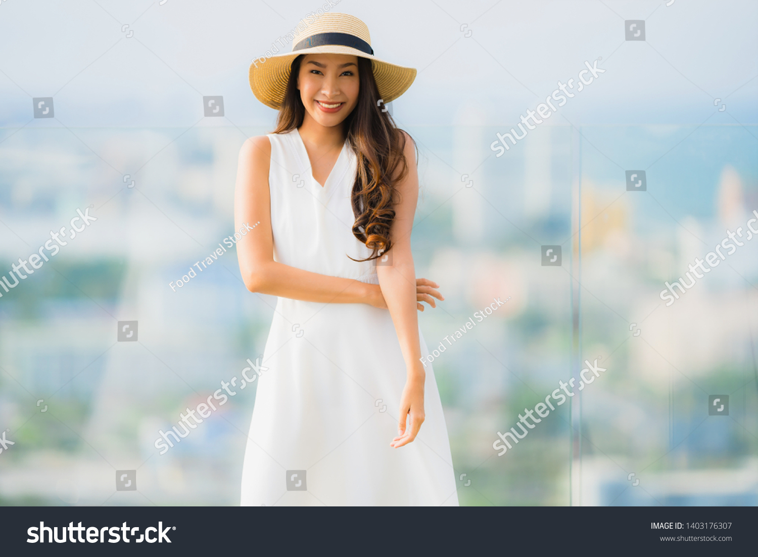 Portrait beautiful young asian woman happy smile relax on the roof top bar for leisure in holiday vacation #1403176307