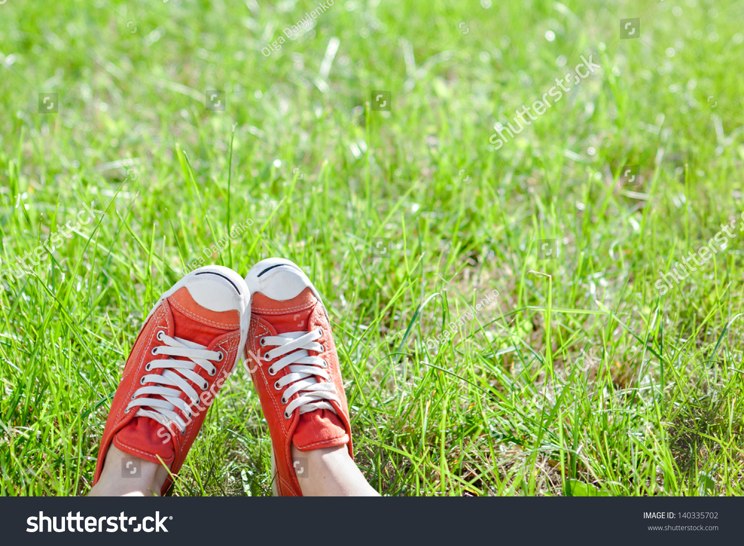 Feet in sneakers on green grass  #140335702