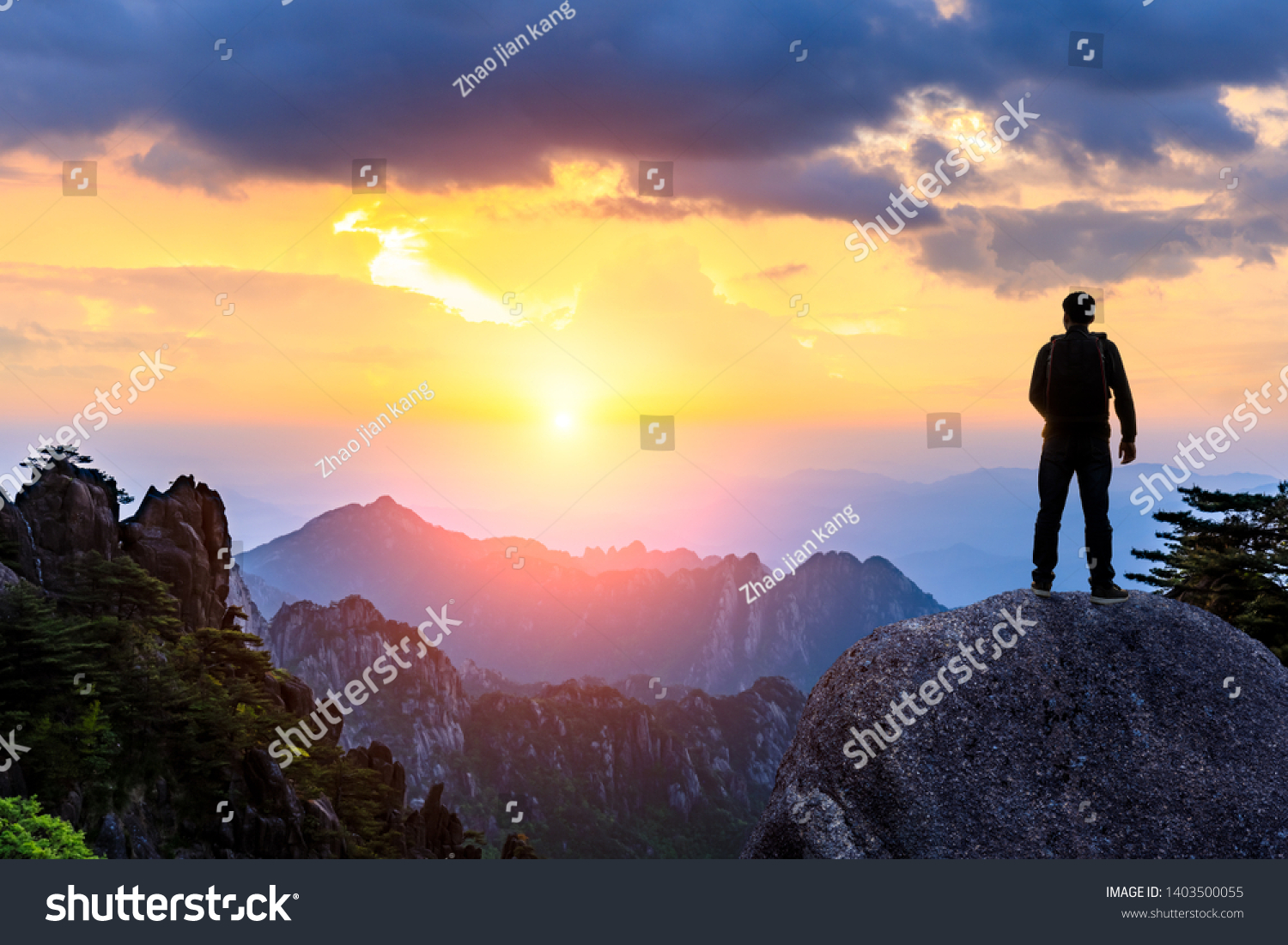 Young happy backpacker on top of a mountain enjoying valley view #1403500055
