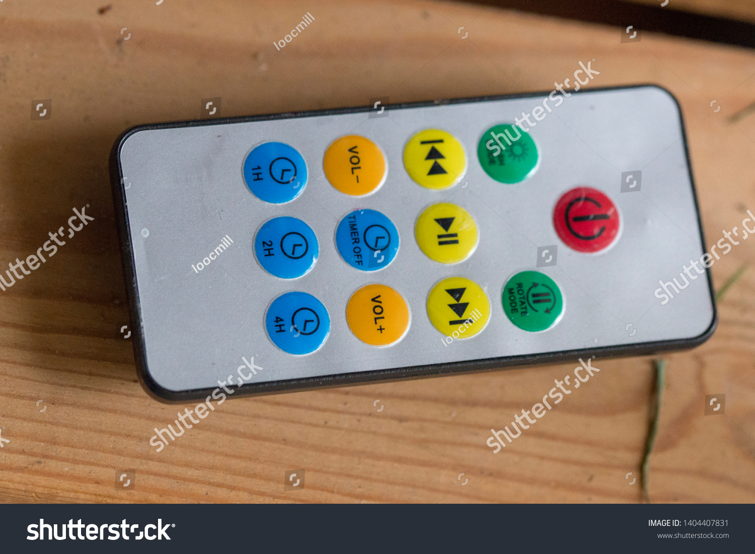 A small handheld remote controller device with colorful buttons to press #1404407831