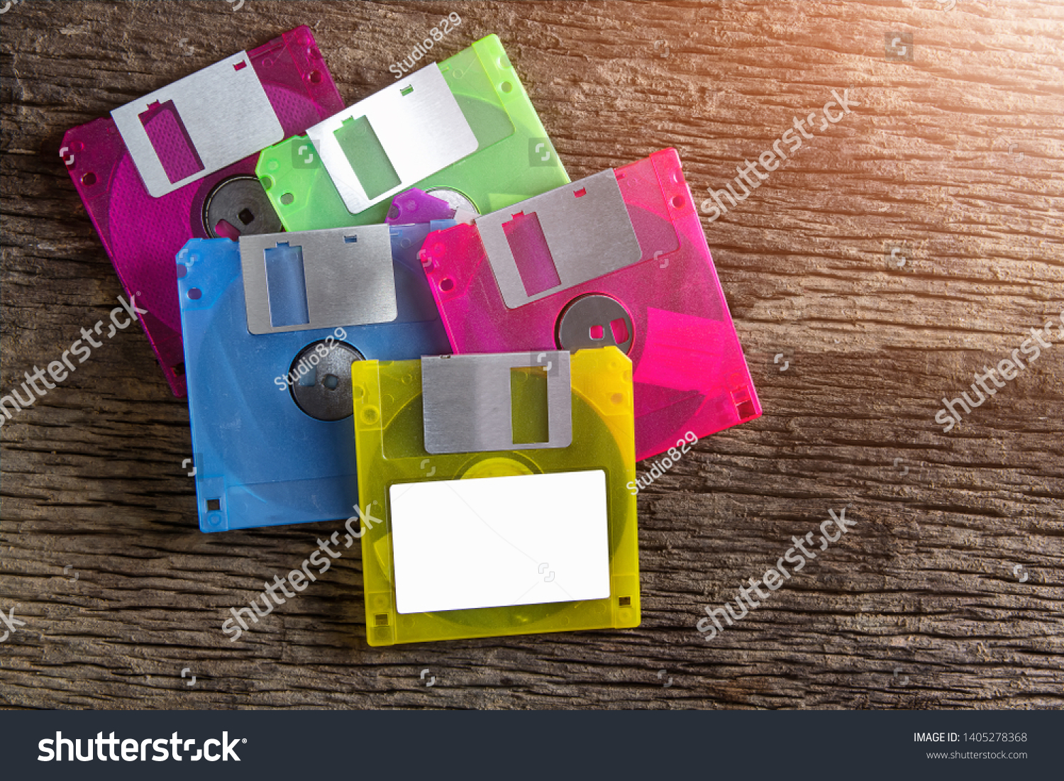 Floppy disks on a wooden table background. #1405278368