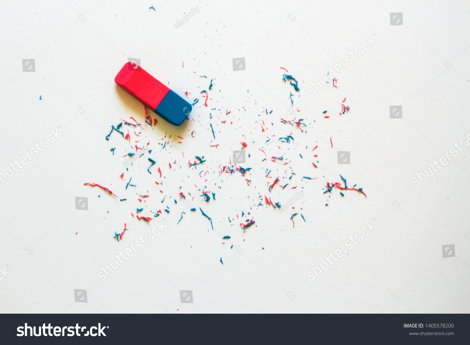Pink and blue eraser and it’s shavings sitting on a clean white sheet of paper with copy space – Small office supply for correcting errors – Concept image for erasing mistakes and editing #1405578200