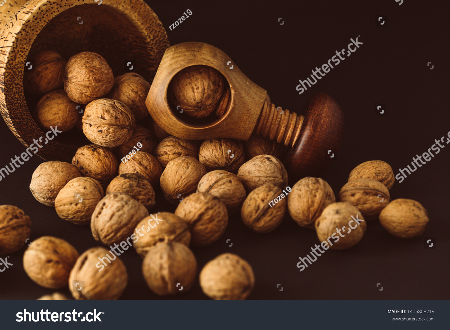 Italian nuts. Wooden nutcracker. Scattered nuts on a table with shallow depth of depth and depth. #1405808219