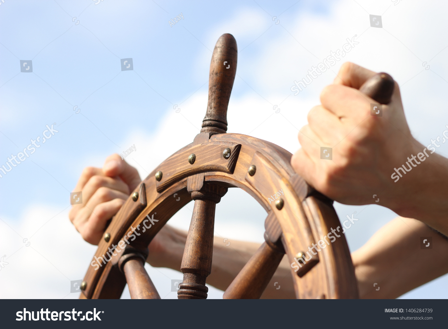 Steering hand wheel ship on sky background, hand hold hand wheel #1406284739