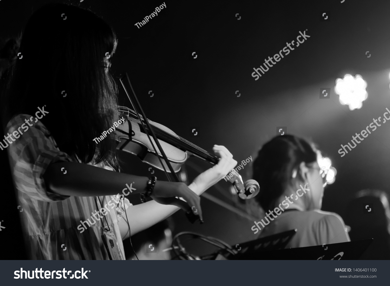 Young Violinist Girl Performance with Her Violin iNstrument on the indoor Concert Stage. Black and White. #1406401100