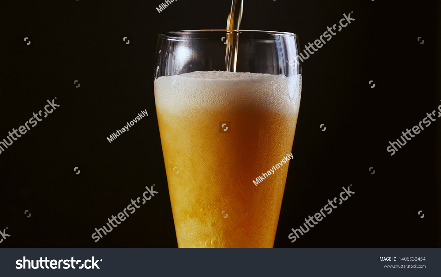 bubbles in the beer in the glass. the beer is poured into a beer glass and it flows in foam in a glass #1406533454
