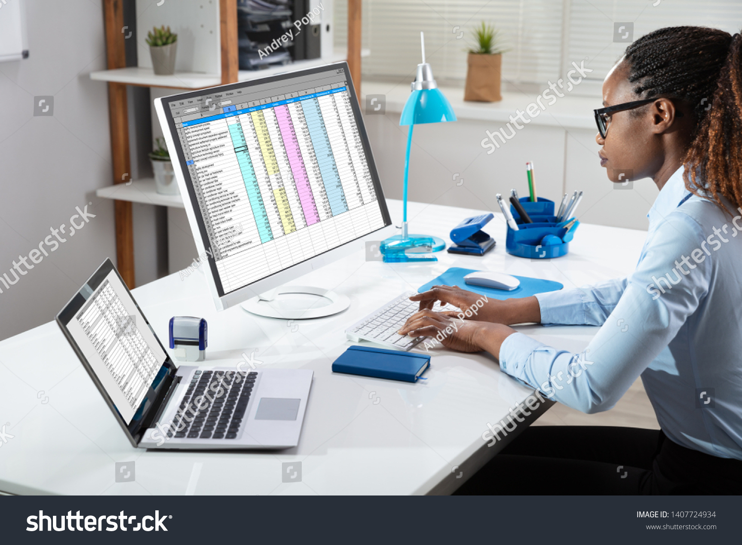 Side View Of Businesswoman's Hand Analyzing Data On Computer Over Desk #1407724934