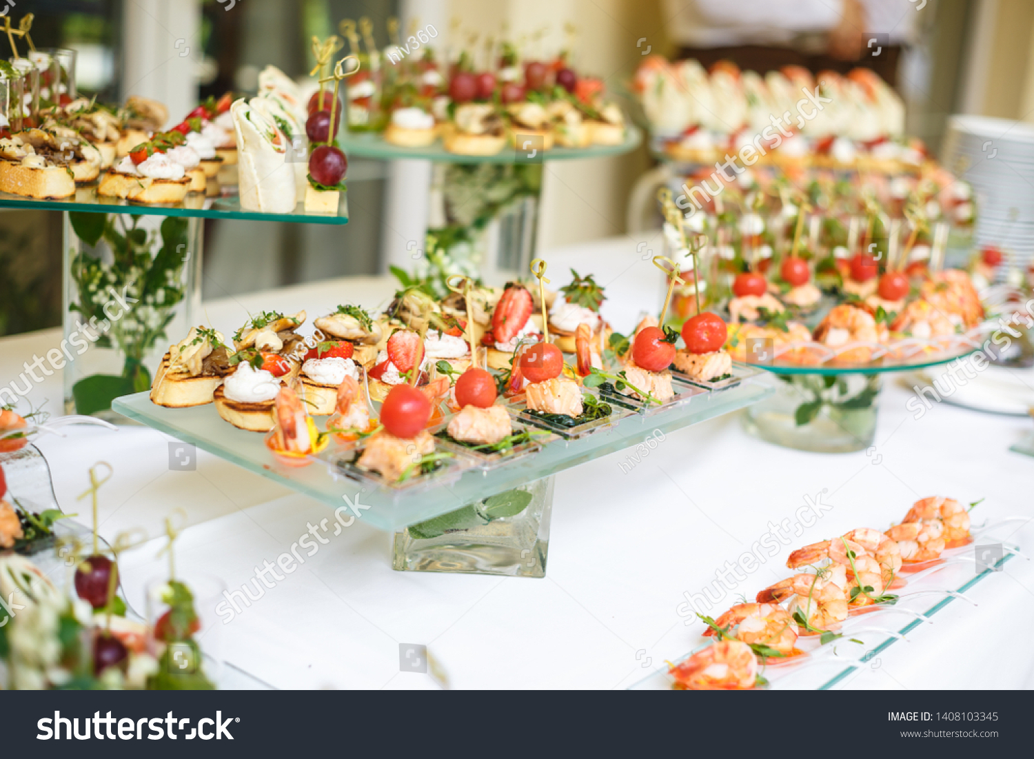 Catering. Off-site food. Buffet table with various canapes, sandwiches, hamburgers and snacks.  #1408103345