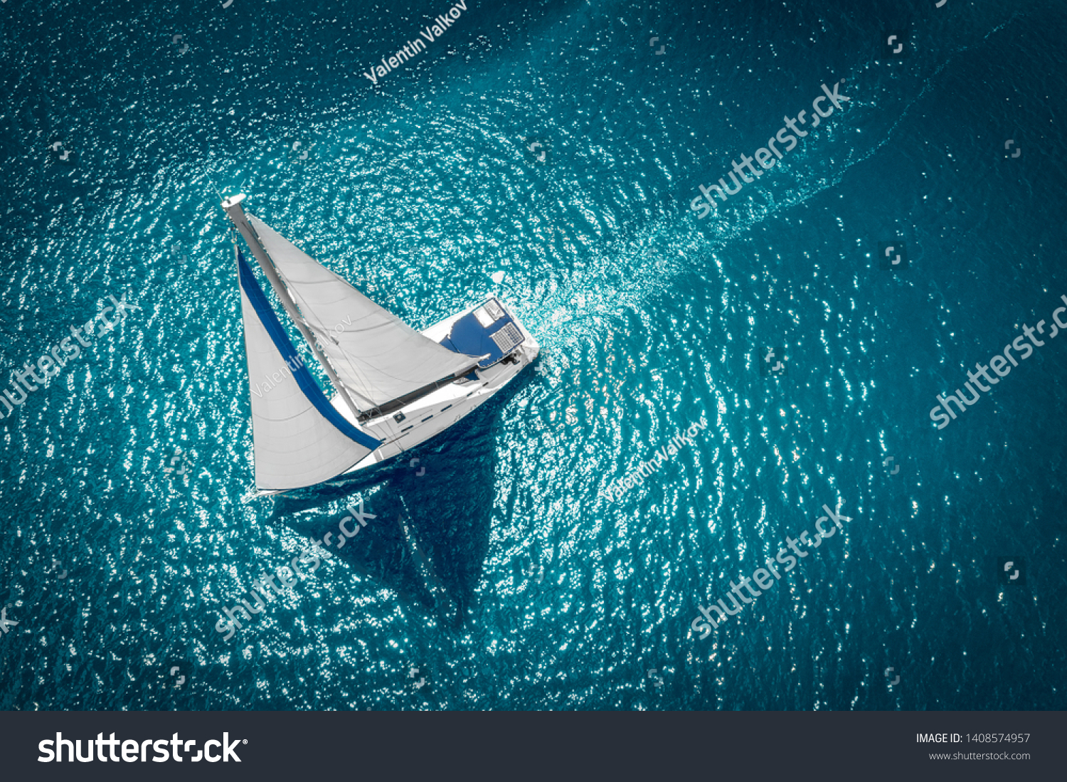 Regatta sailing ship yachts with white sails at opened sea. Aerial view of sailboat in windy condition. #1408574957