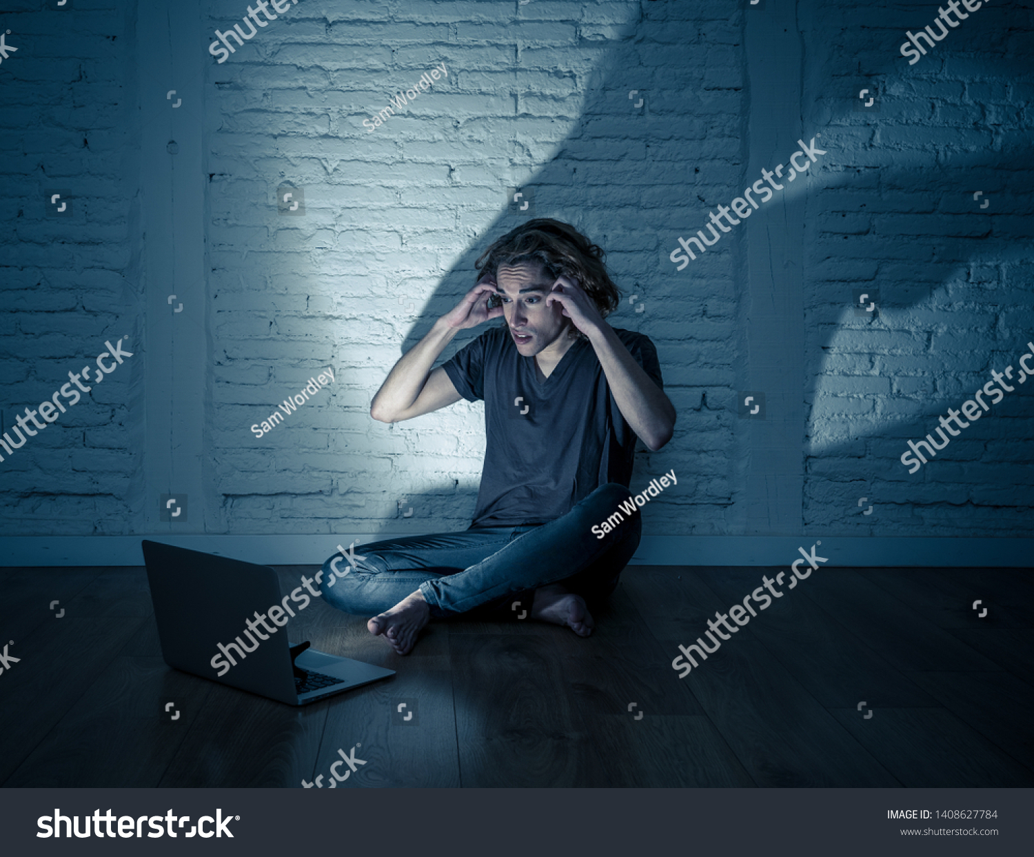 Severely distraught young teen man with laptop suffering cyberbullying and harassment being online abused by stalker or gossip feeling desperate and humiliated in cyber bullying and social media. #1408627784