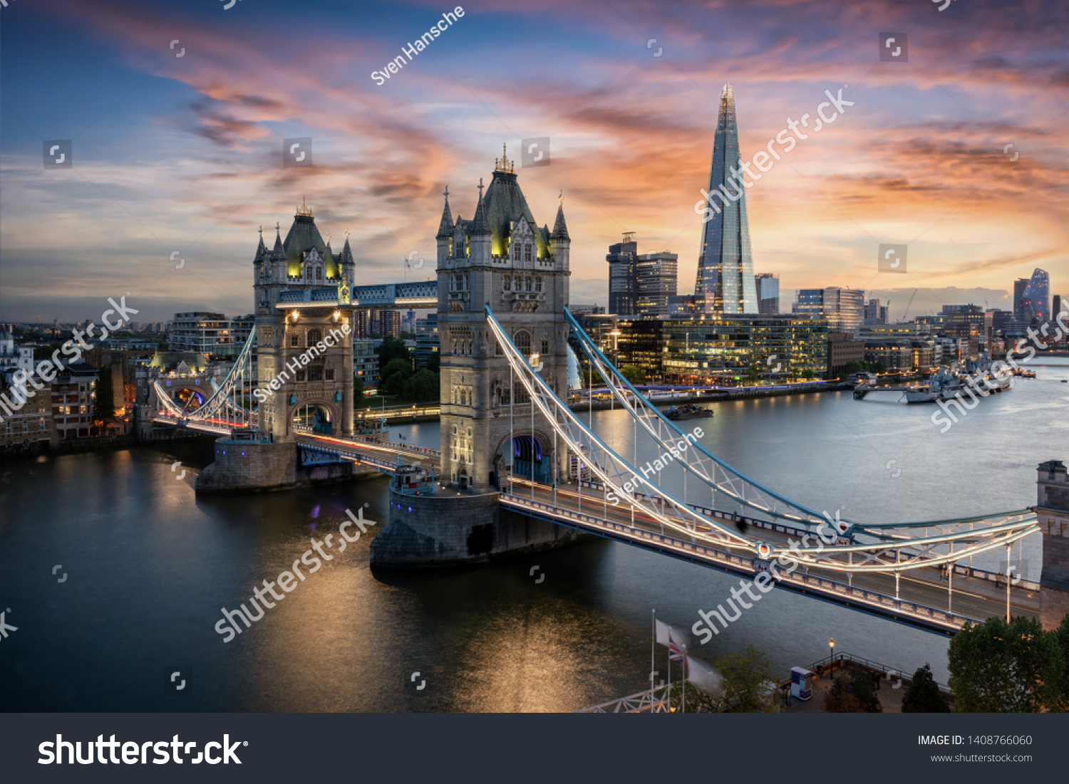 Aerial view to the illuminated Tower Bridge and skyline of London, UK, just after sunset #1408766060