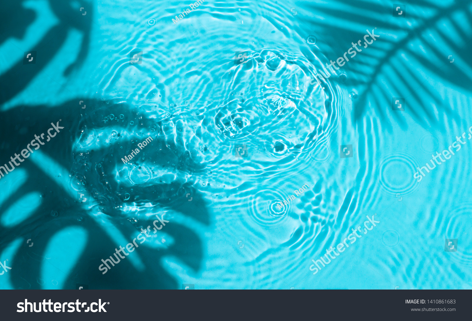Blue water texture background on the noon sunlight with  tropical leaves shadow. 
 #1410861683