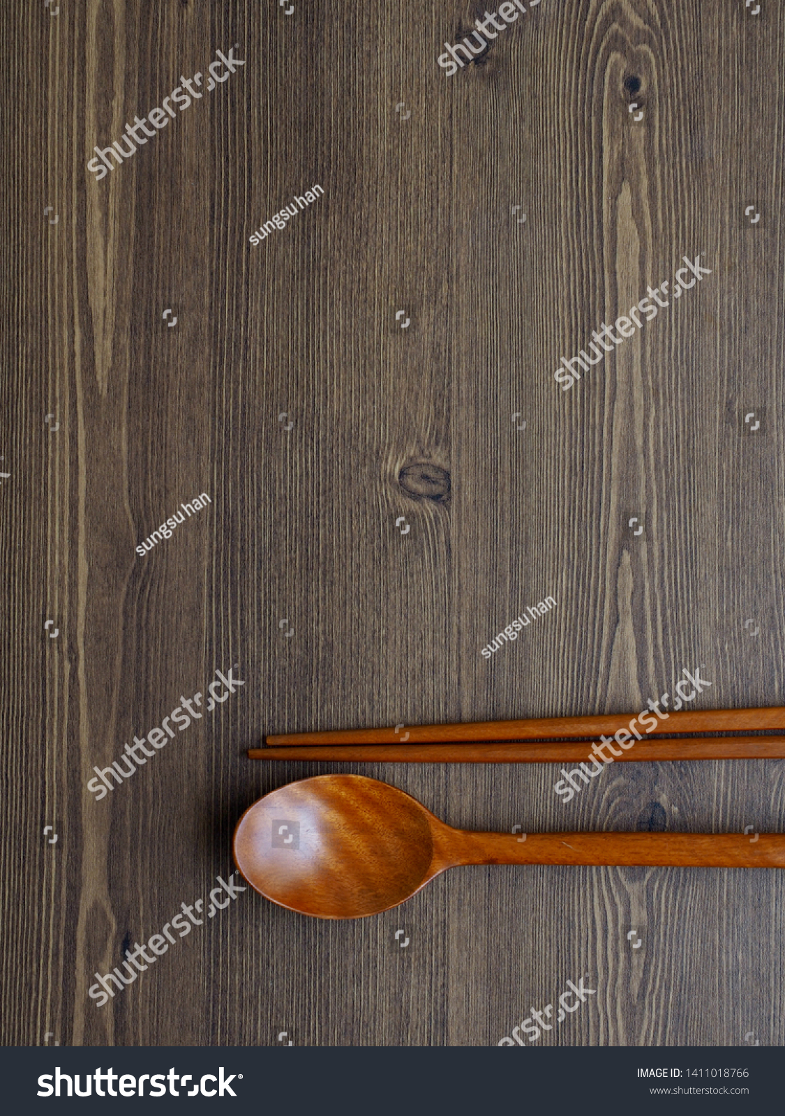Wooden spoon, Wooden chopsticks and Wooden board background
 #1411018766