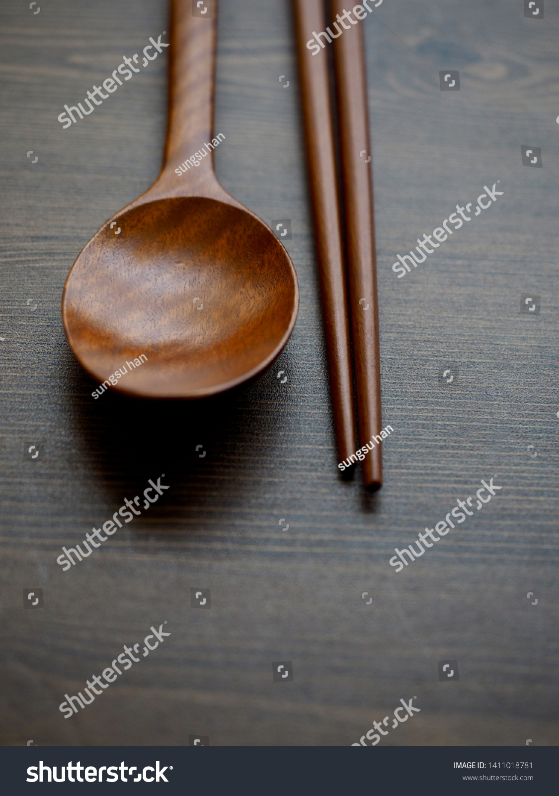 Wooden spoon, Wooden chopsticks and Wooden board background
 #1411018781