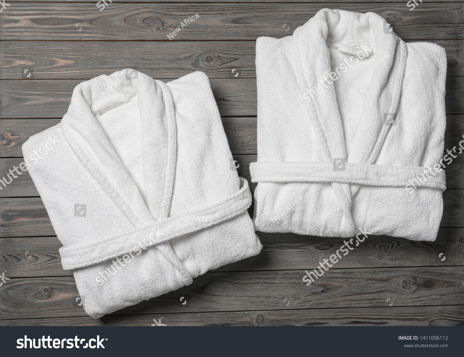 Flat lay composition with folded bathrobes on wooden background #1411096112