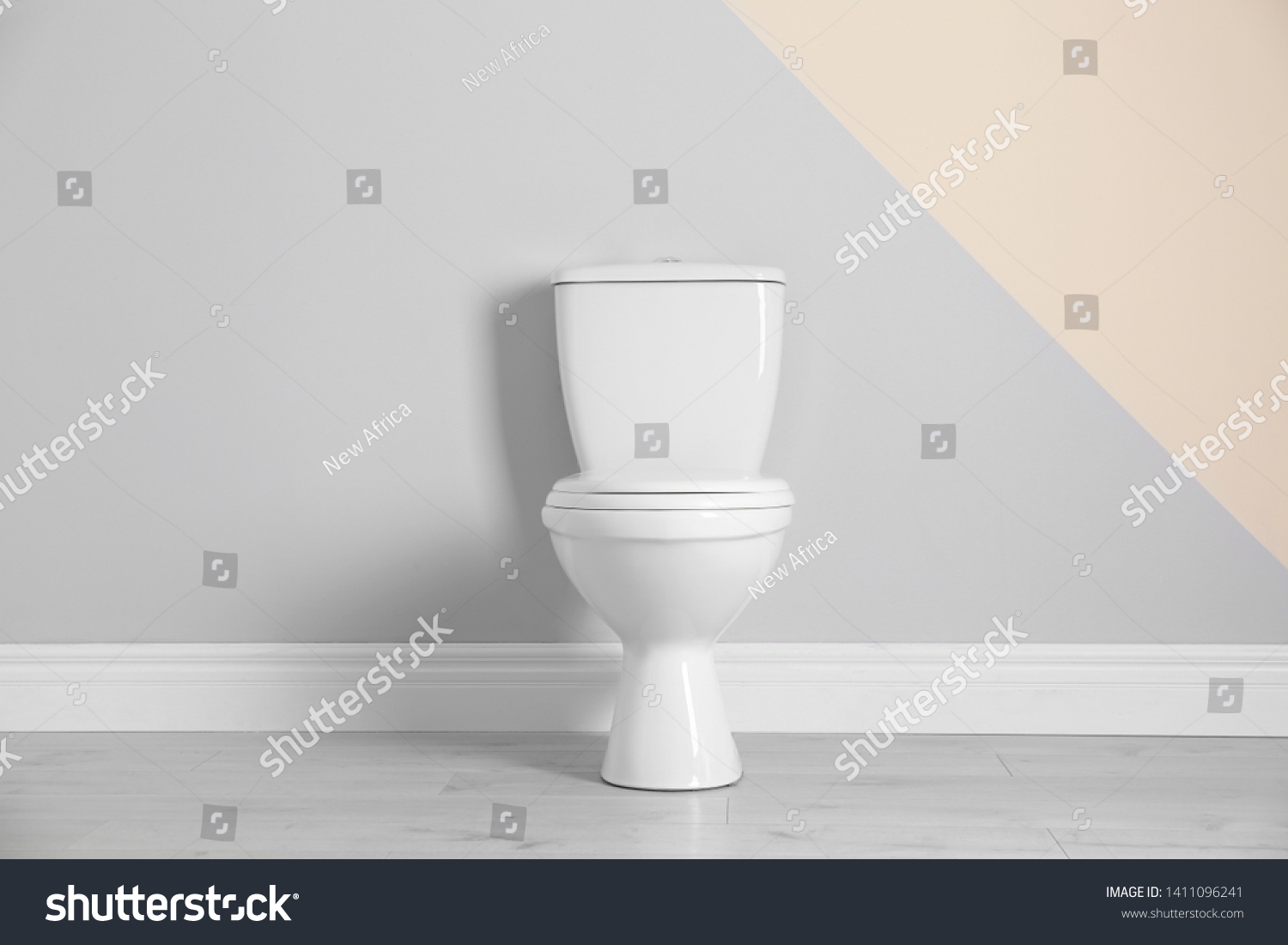 New toilet bowl near color wall indoors #1411096241