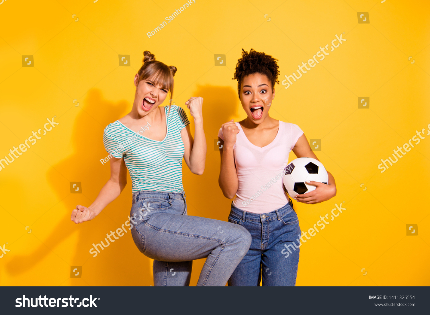 Portrait cheerful student hold hand energy achieve beautiful bun excited scream goal success sporty luck raise fists wavy curly jeans top-knot trendy style stylish t-shirt isolated yellow background #1411326554