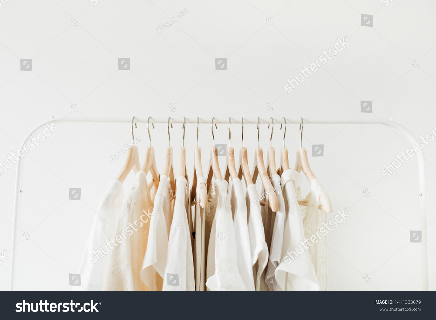 Minimal fashion clothes concept. Female blouses and t-shirts on hanger on white background. Fashion blog, website, social media hero header. #1411333679