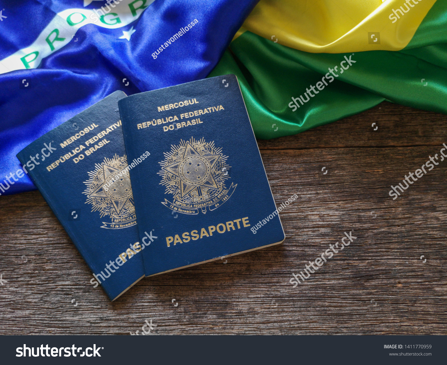 Brazilian flag with Brazilian passport and wooden background #1411770959