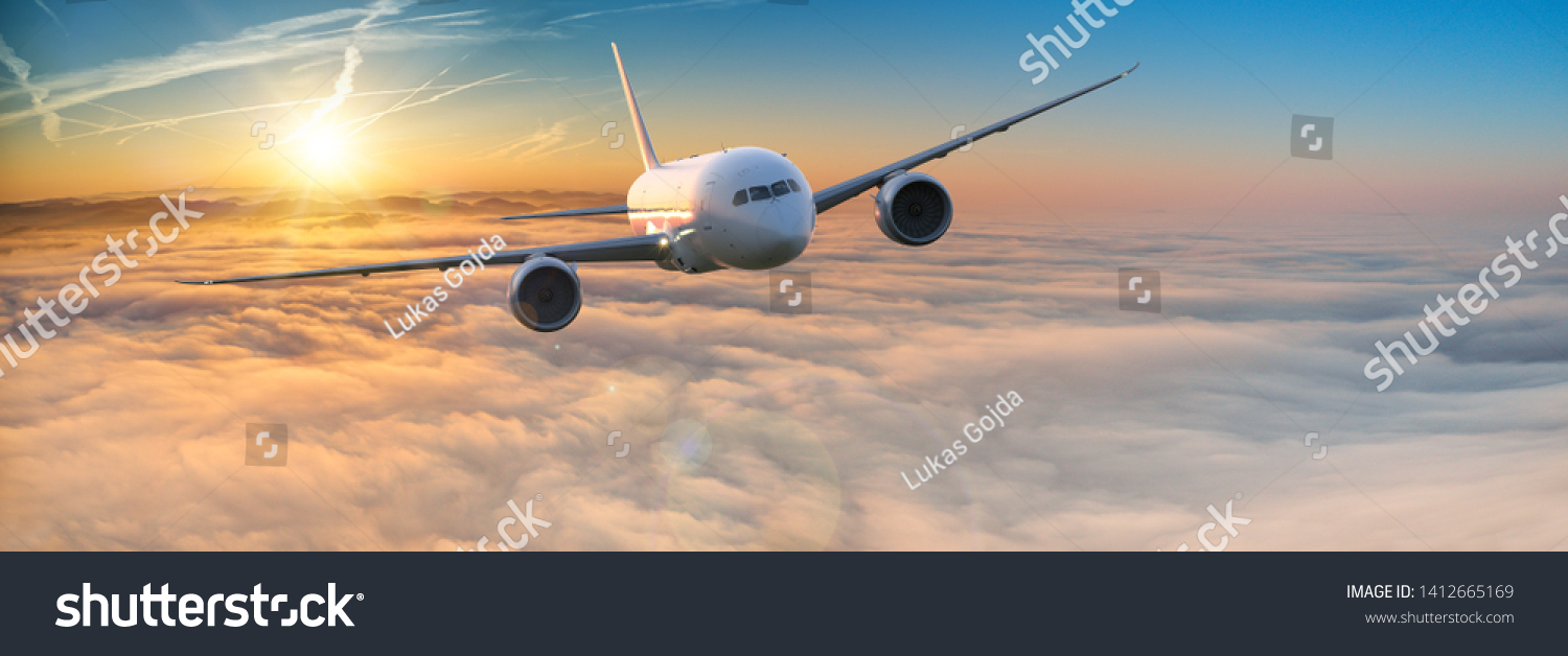 Commercial airplane jetliner flying above dramatic clouds in beautiful light. Travel concept. #1412665169