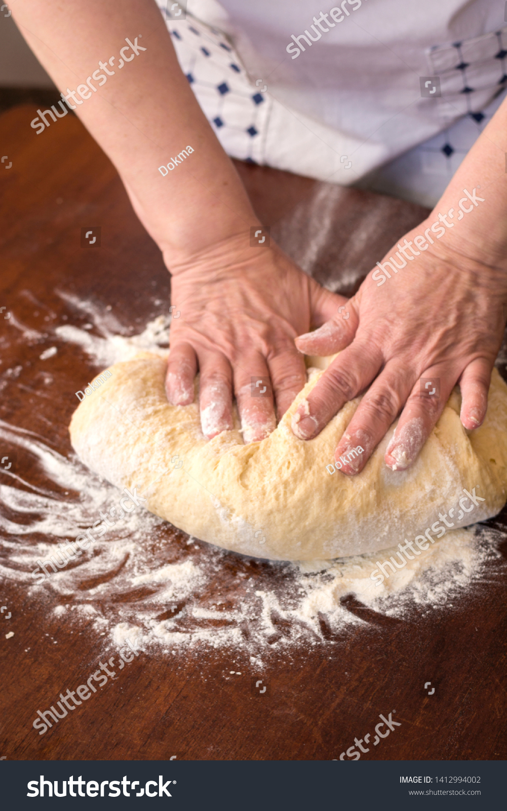 Woman making yeast dough at home #1412994002