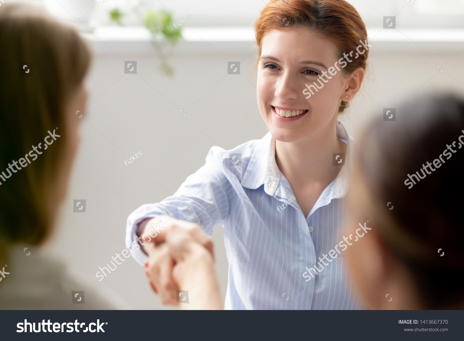 Smiling businesswoman greeting shaking hand female client, new colleague, vacancy candidate at meeting in office. Hiring sale bank investment deal start of negotiations job seeker applicant interview #1413667370