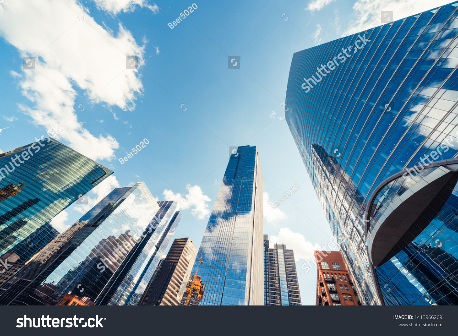 Modern tower buildings or skyscrapers in financial district with cloud on sunny day in Chicago, USA. Construction industry, business enterprise organization, or communication technology concept #1413966269