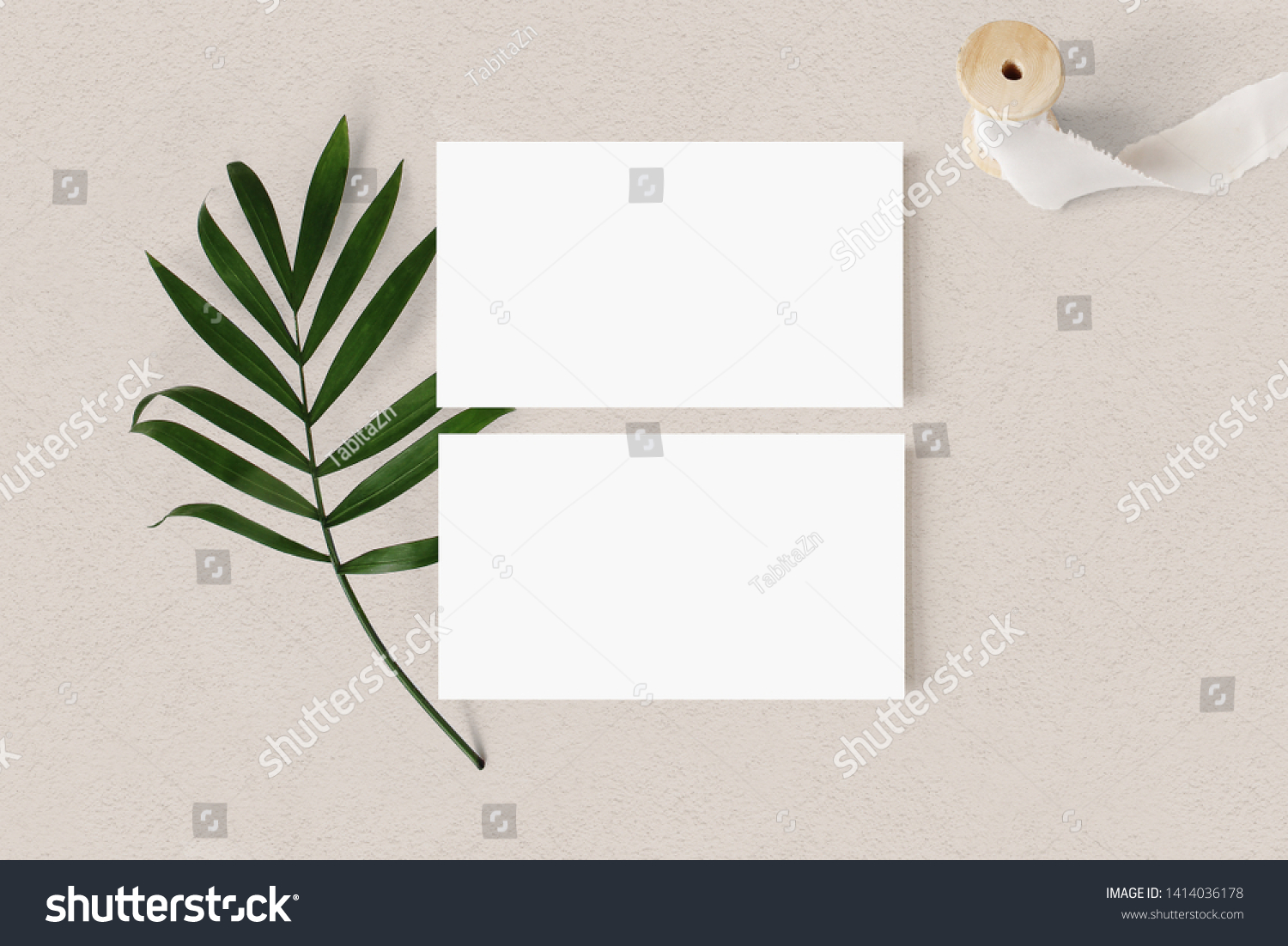 Blank white business cards mockups with palm leaf and silk ribbon on textured table backgound. Elegant modern template for branding identity. Tropical design. Wedding stationery. Flat lay, top view. #1414036178
