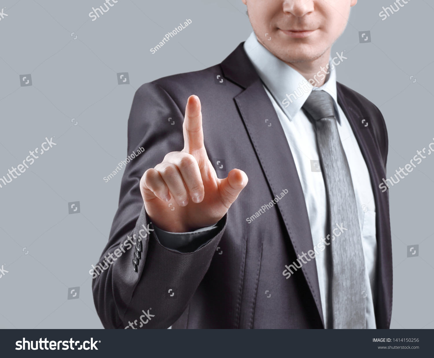 close up. businessman presses his finger on the virtual point. isolated on grey background #1414150256