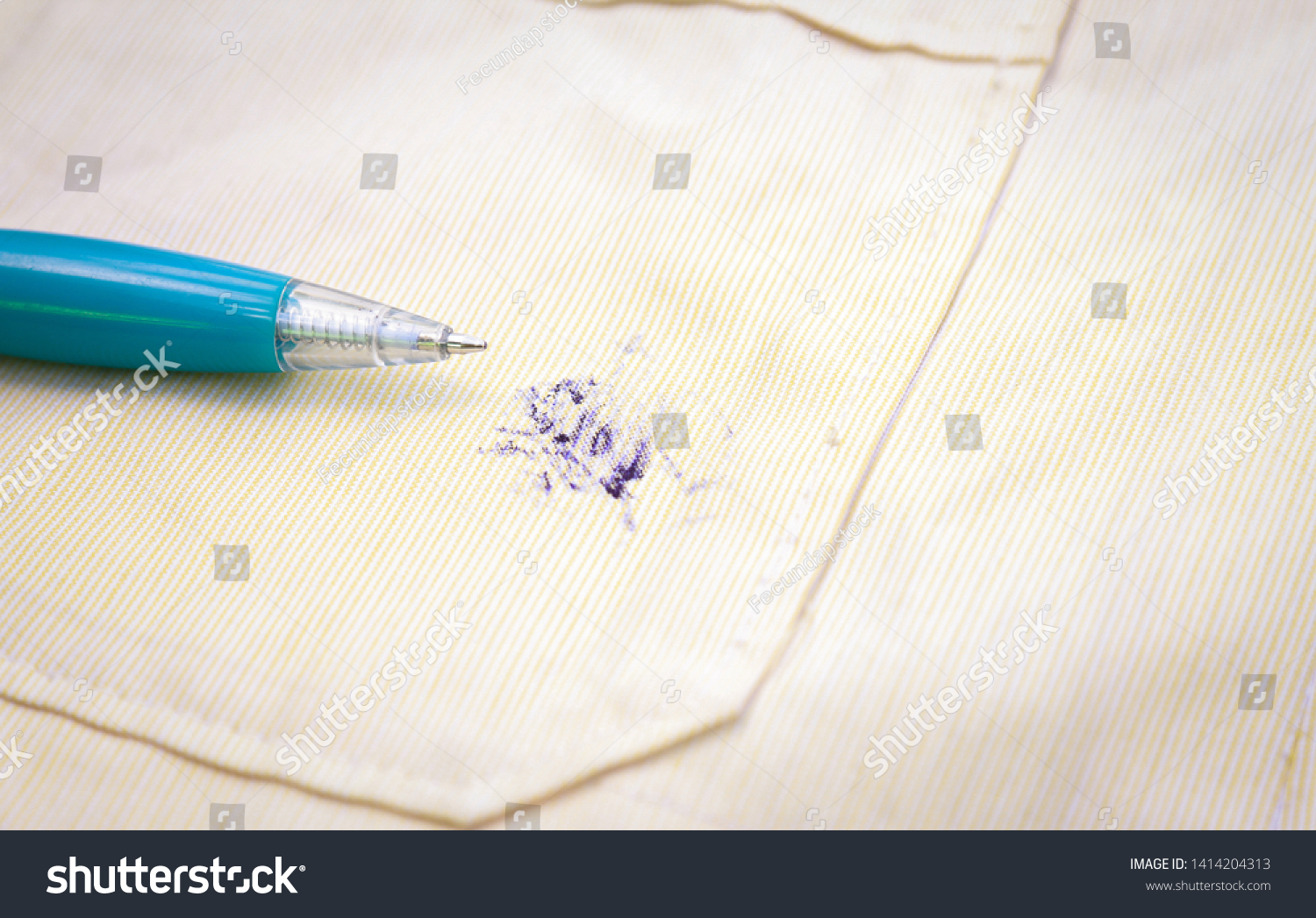 Dirty ink pen stain on fabric from accident in daily life. dirt stains for cleaning work house  #1414204313