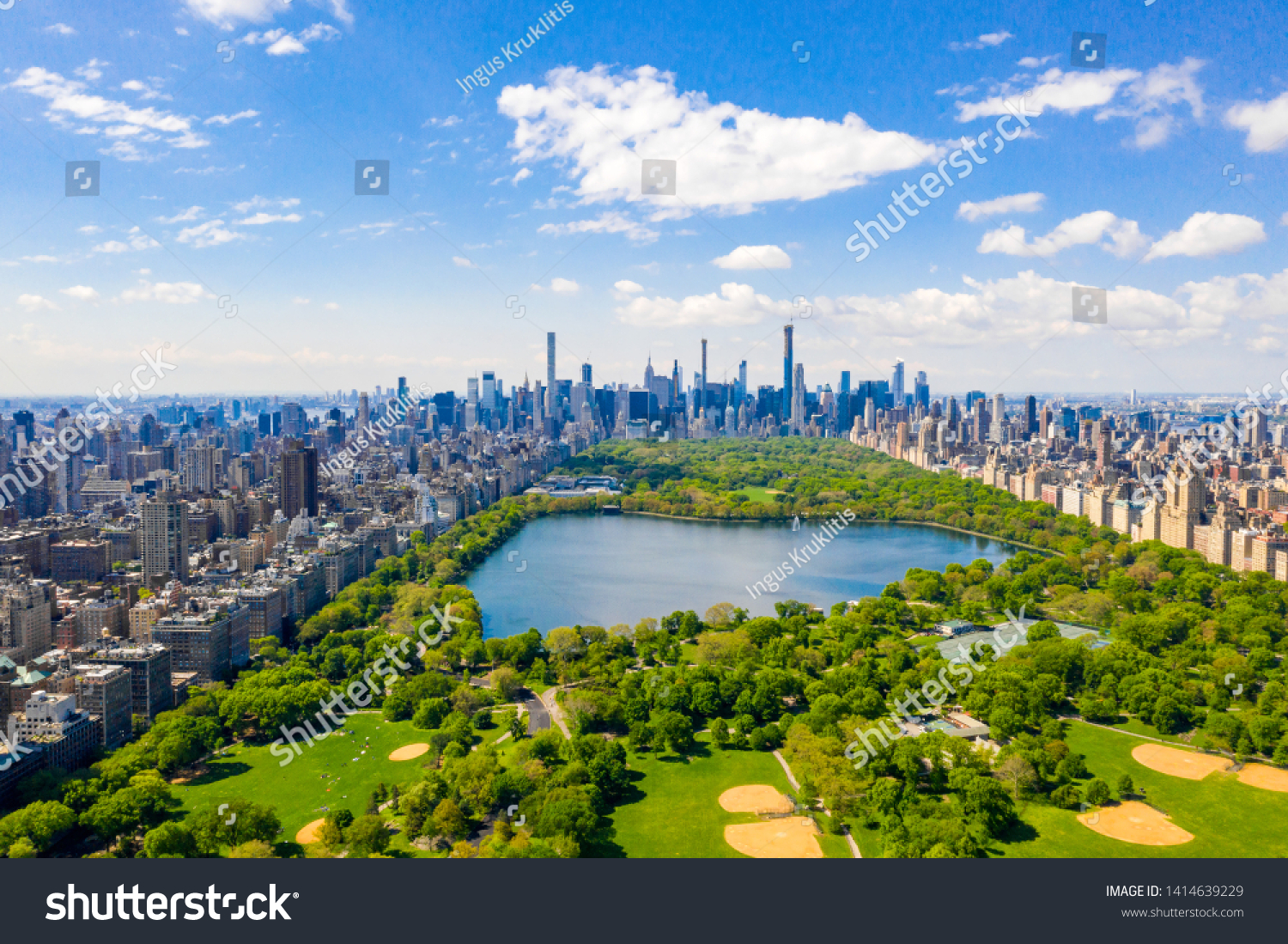 Aerial view of the Central park in New York with golf fields and tall skyscrapers surrounding the park. #1414639229