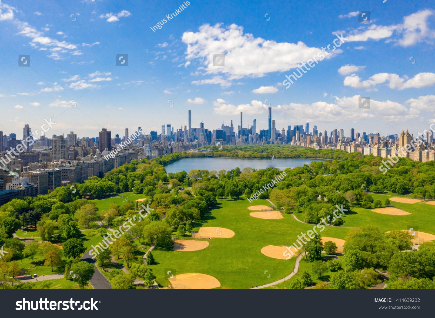Aerial view of the Central park in New York with golf fields and tall skyscrapers surrounding the park. #1414639232