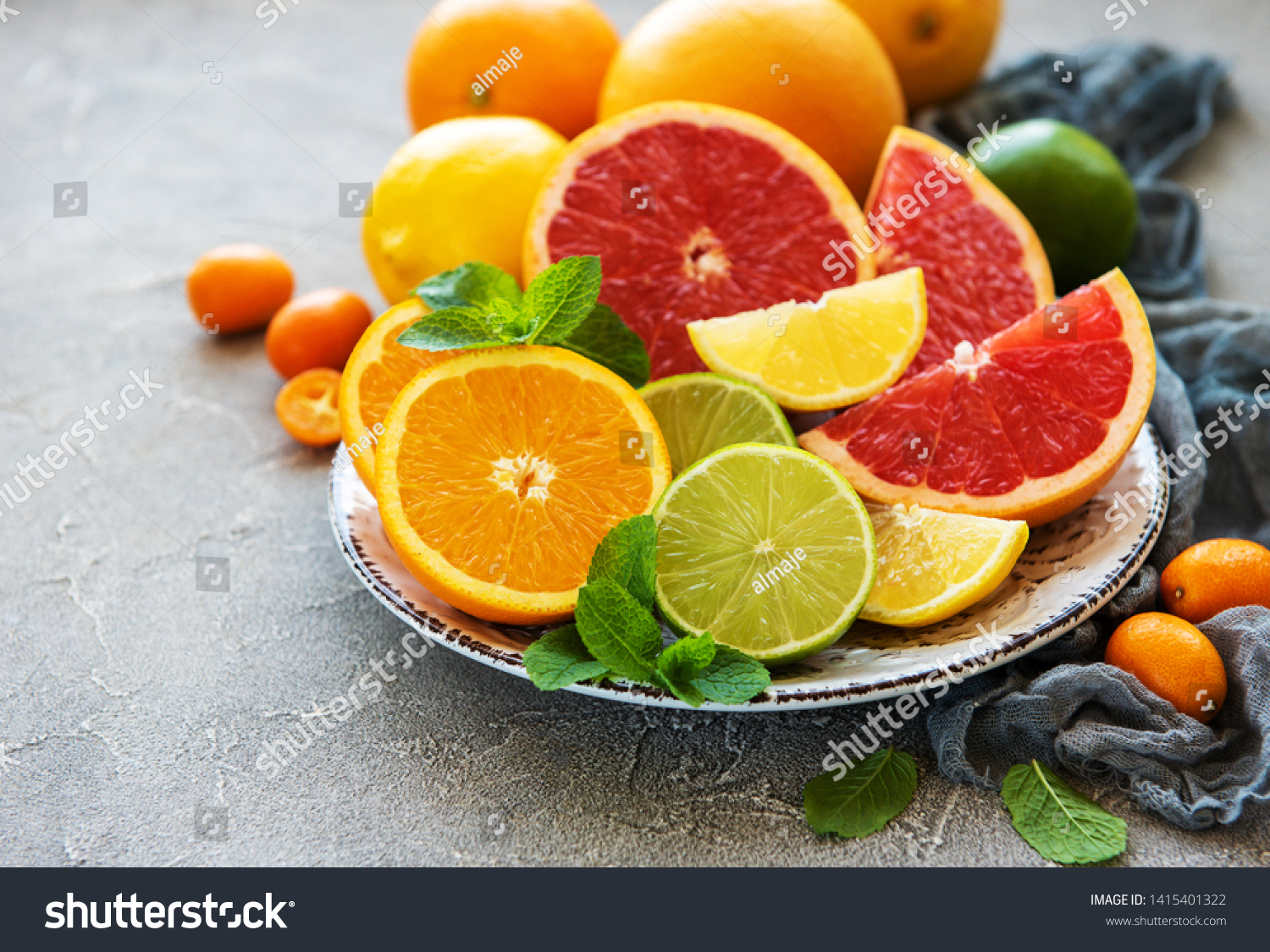 Plate with citrus fresh fruits on a concrete background #1415401322